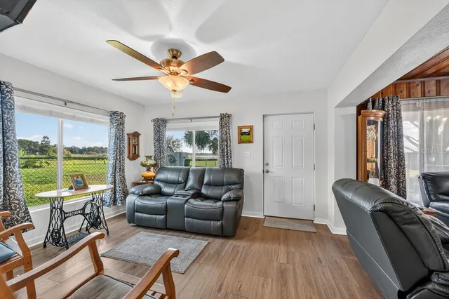 a living room with furniture and a large window with outer view