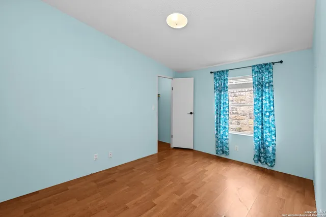 a view of a balcony with wooden floor and fence