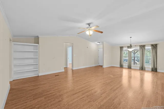 a kitchen with white cabinets and sink
