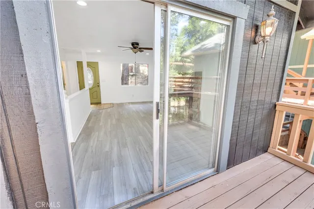 a view of a hallway with wooden floor and dining room