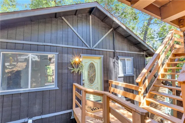 a view of a house with large windows and a small yard