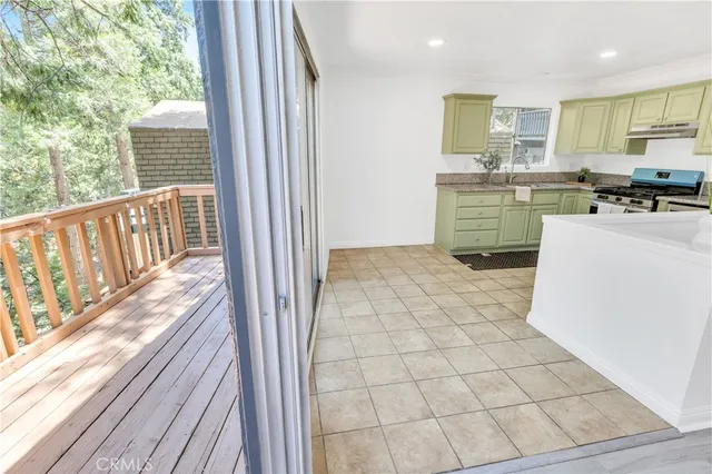 a view of kitchen with kitchen island microwave and stove top oven
