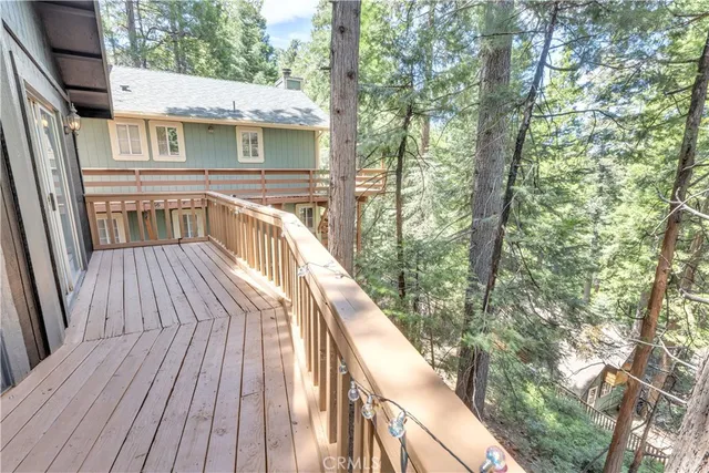 a view of balcony with wooden floor and fence