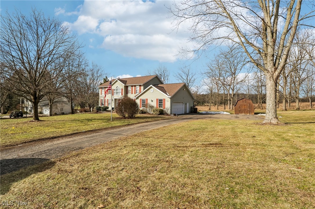 3530 State Road Medina, OH 44256 - Photo 2 of 47 View of front of property with a storage shed, a garage, and a front yard
