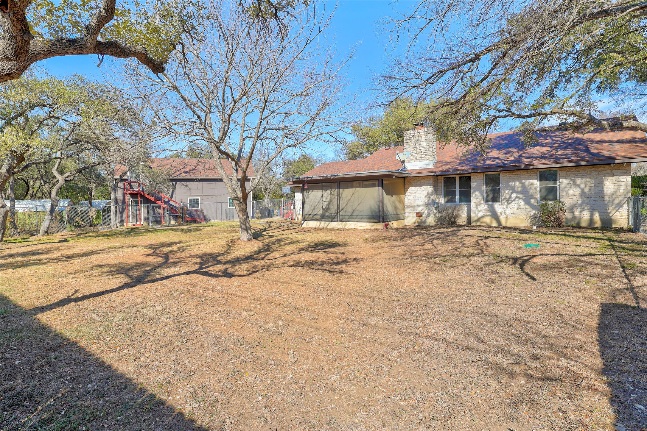 238 Mesa Drive Georgetown, TX 78628 - Photo 30 of 32 Rear view of house with a chimney and brick siding