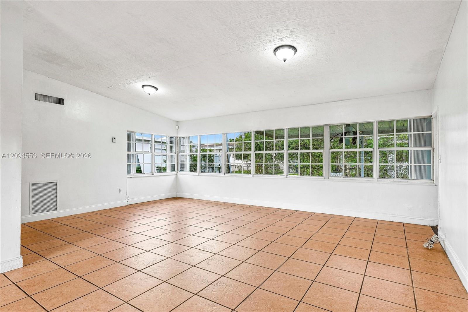 571 Northeast 172nd Street North Miami Beach, FL 33162 - Photo 13 of 33 Bright family room with a wall of windows