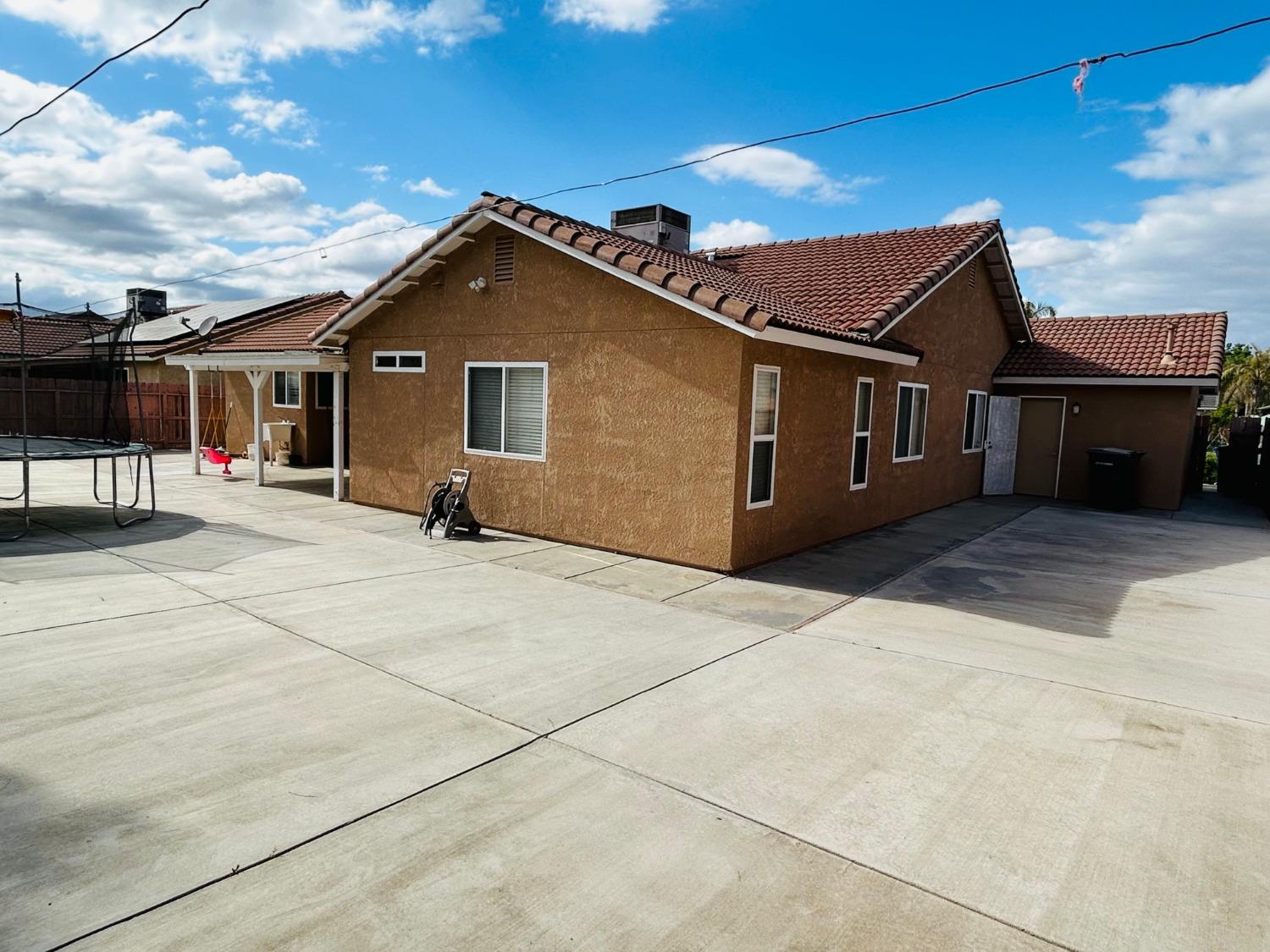 14039 West F Street Kerman, CA 93630 - Photo 18 of 19 a view of house with backyard