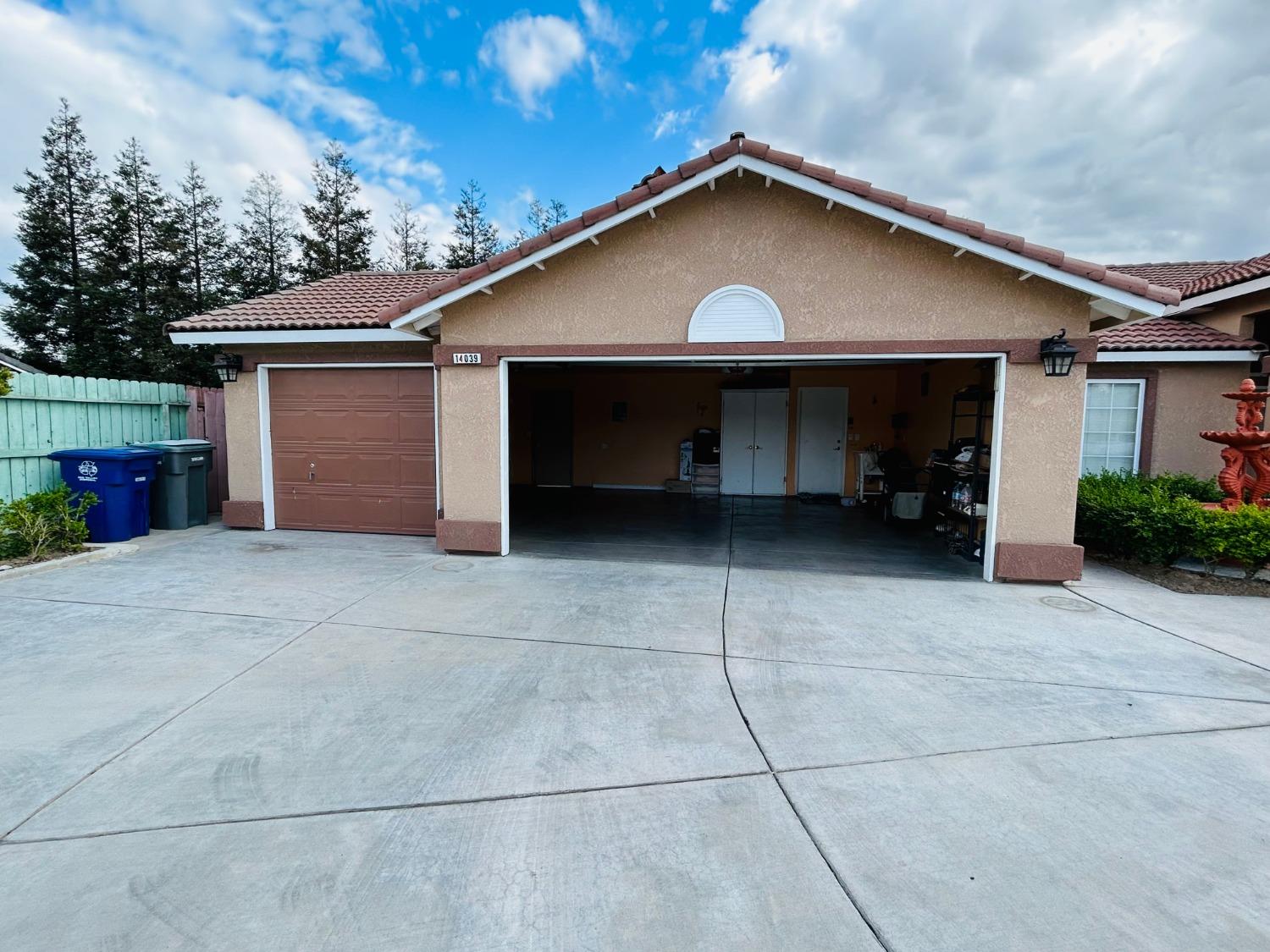 14039 West F Street Kerman, CA 93630 - Photo 19 of 19 a front view of a house with a yard and garage