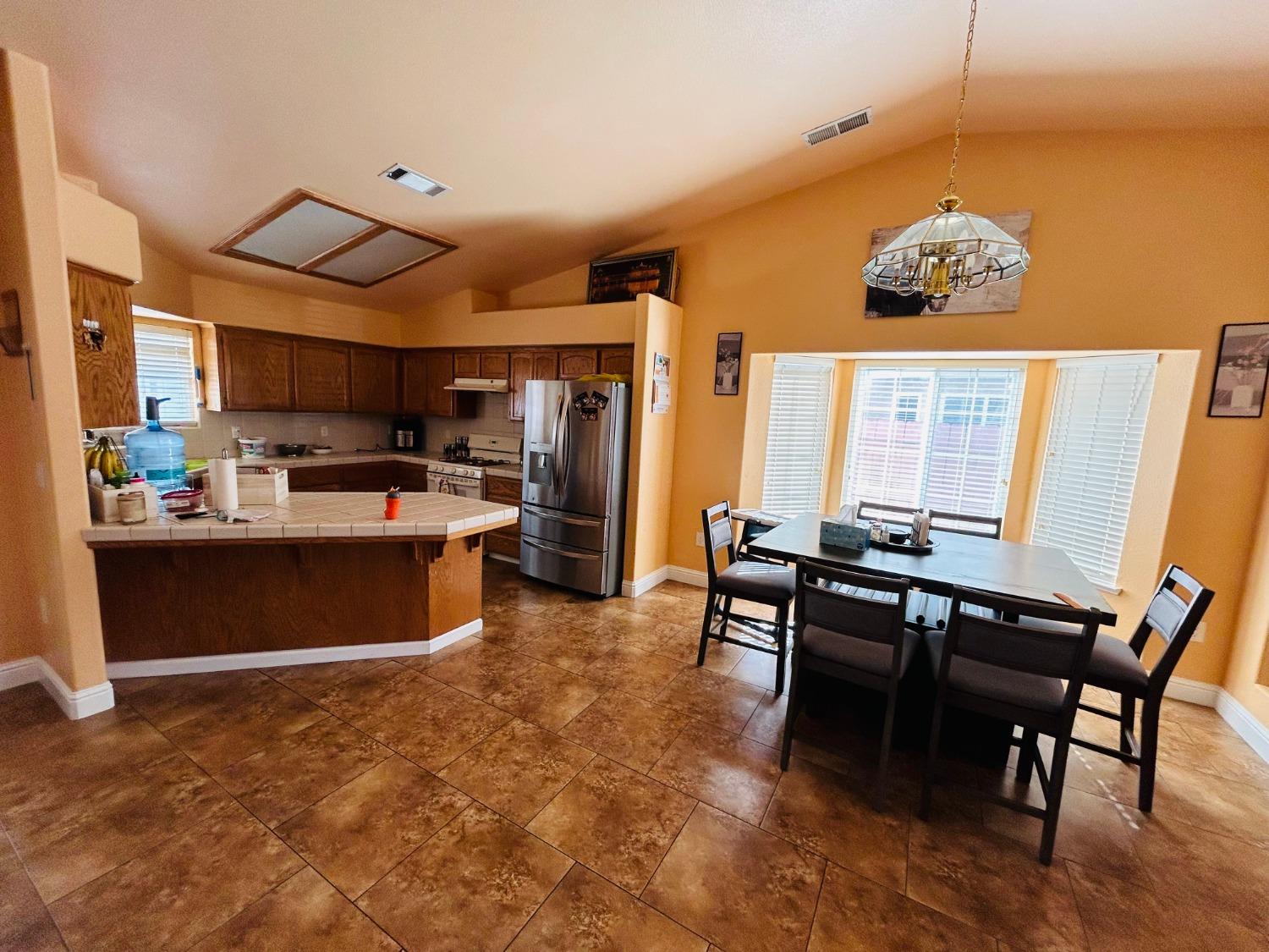 14039 West F Street Kerman, CA 93630 - Photo 8 of 19 a kitchen with a sink cabinets and window