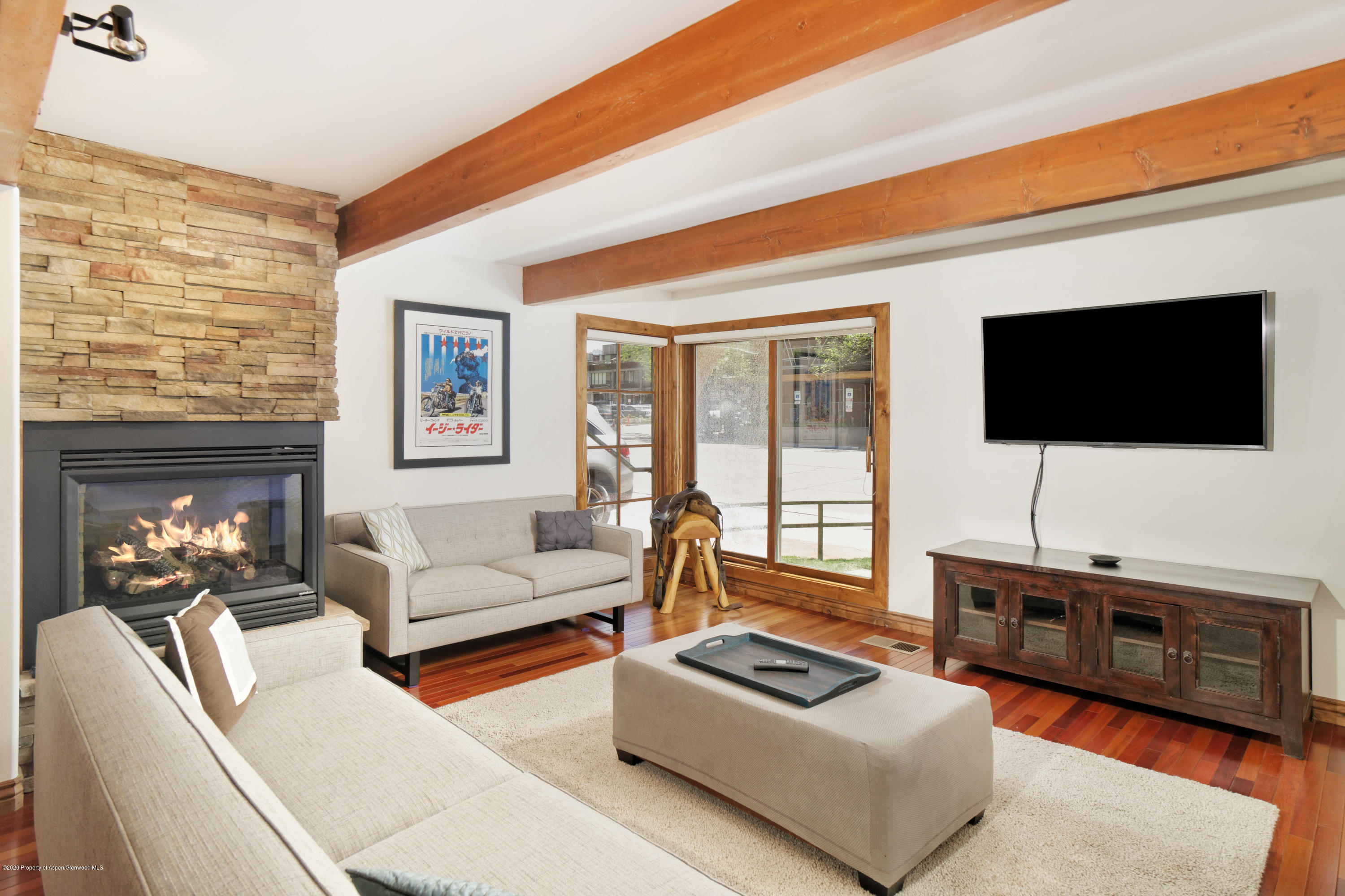 630 East Cooper Avenue, Unit 1 Aspen, CO 81611 - Photo 1 of 25 a living room with furniture and a flat screen tv