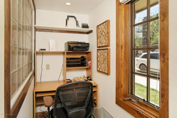 a view of workspace with wooden floor and windows