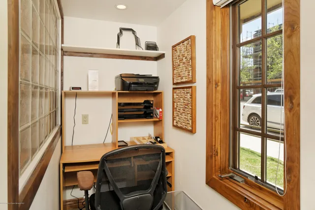 a view of workspace with wooden floor and windows