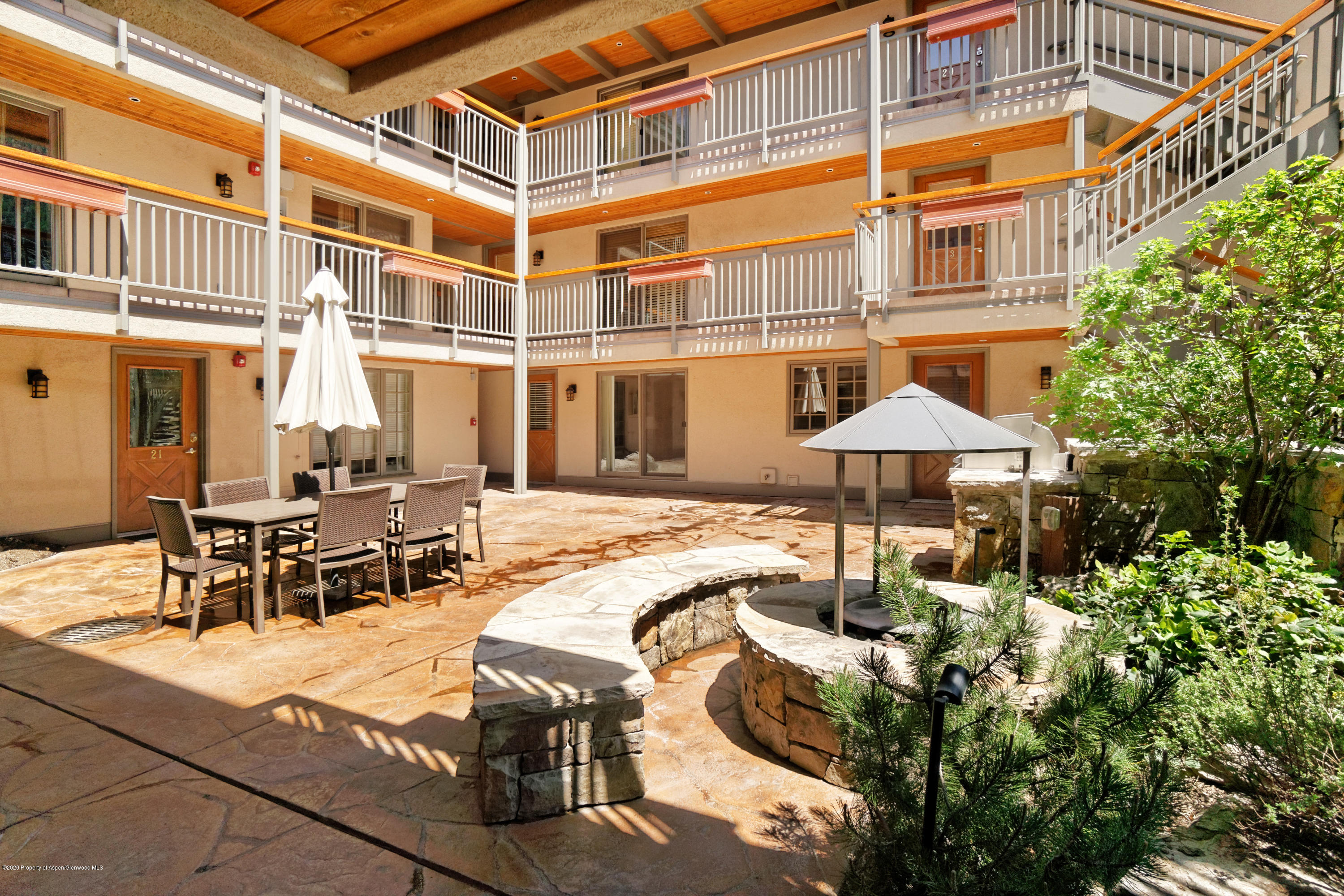 630 East Cooper Avenue, Unit 1 Aspen, CO 81611 - Photo 14 of 25 a view of a patio with table and chairs under an umbrella