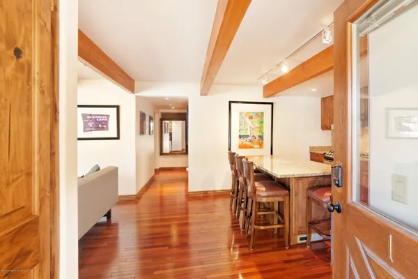 a view of a dining room with furniture and wooden floor