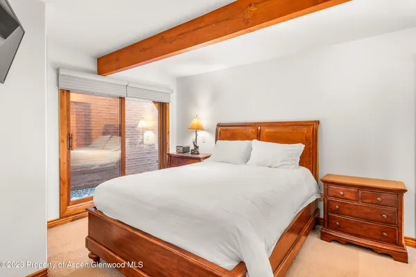 a bedroom with a bed and large window