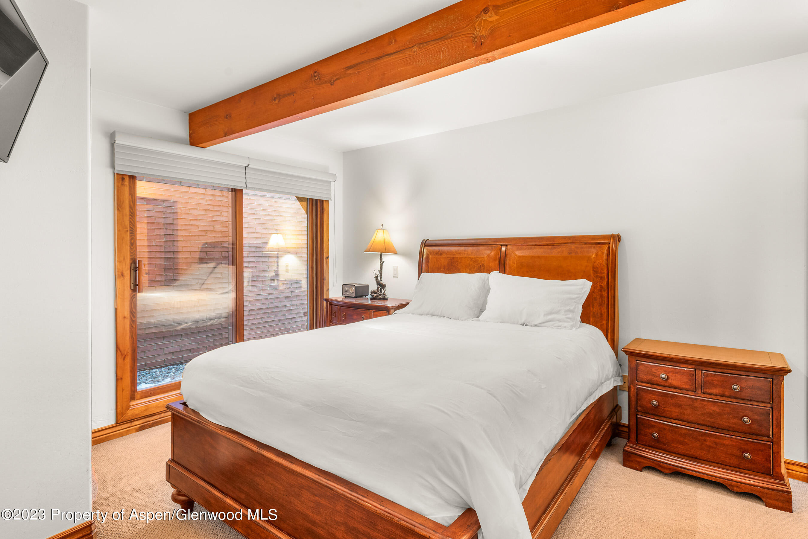 630 East Cooper Avenue, Unit 1 Aspen, CO 81611 - Photo 7 of 25 a bedroom with a bed and large window