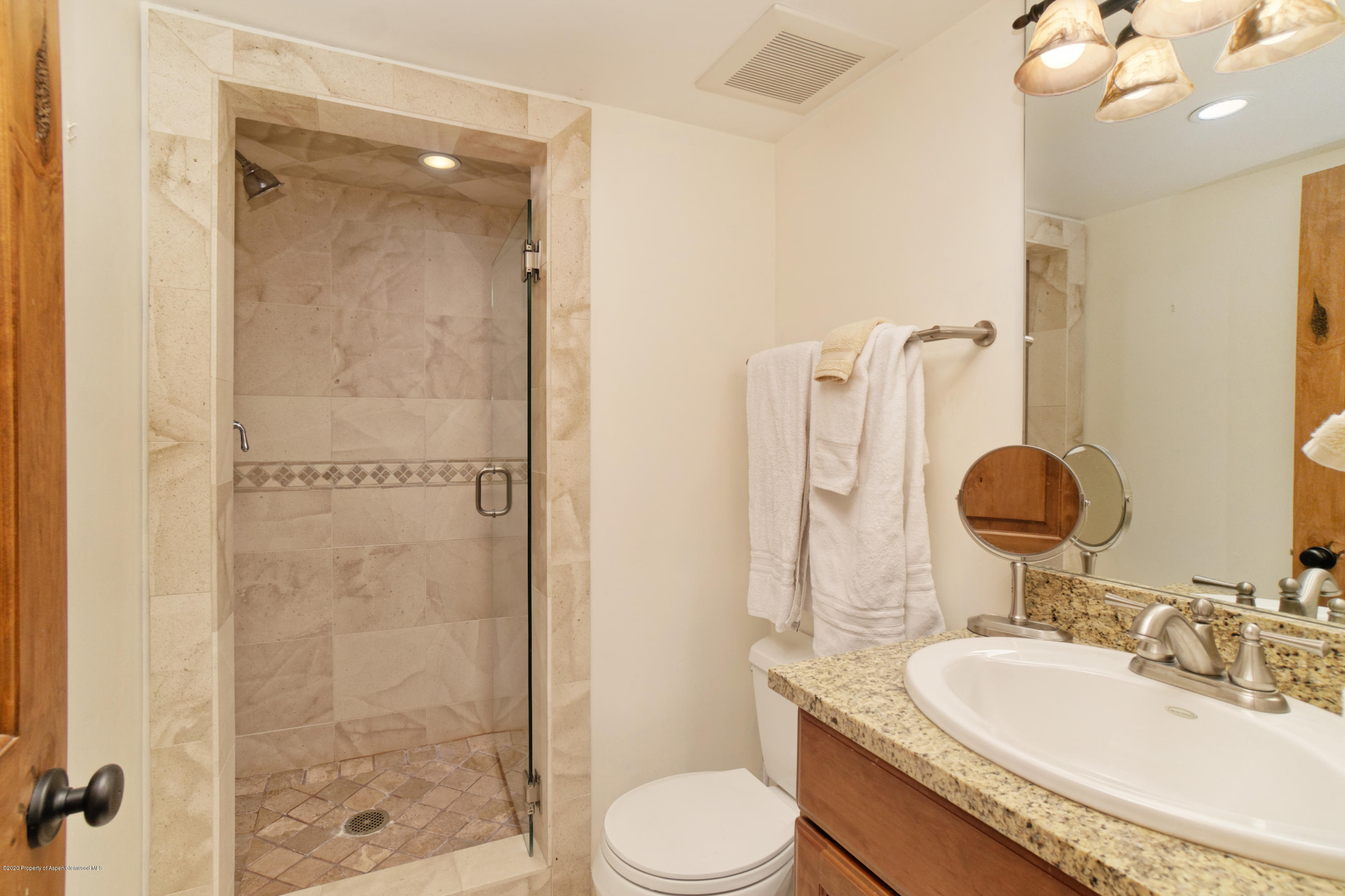 630 East Cooper Avenue, Unit 1 Aspen, CO 81611 - Photo 8 of 25 a bathroom with a granite countertop sink toilet and shower