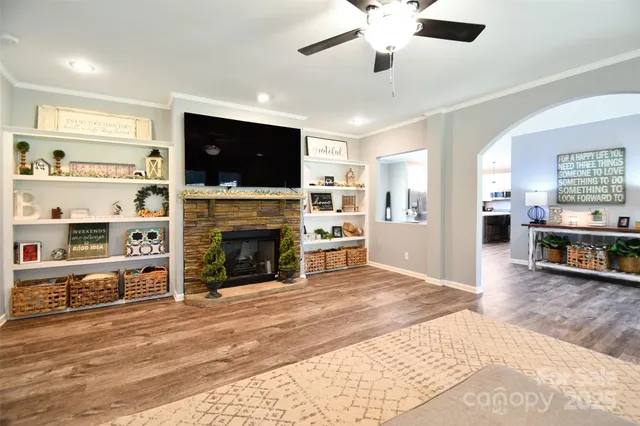 a living room with furniture a flat screen tv and a fireplace