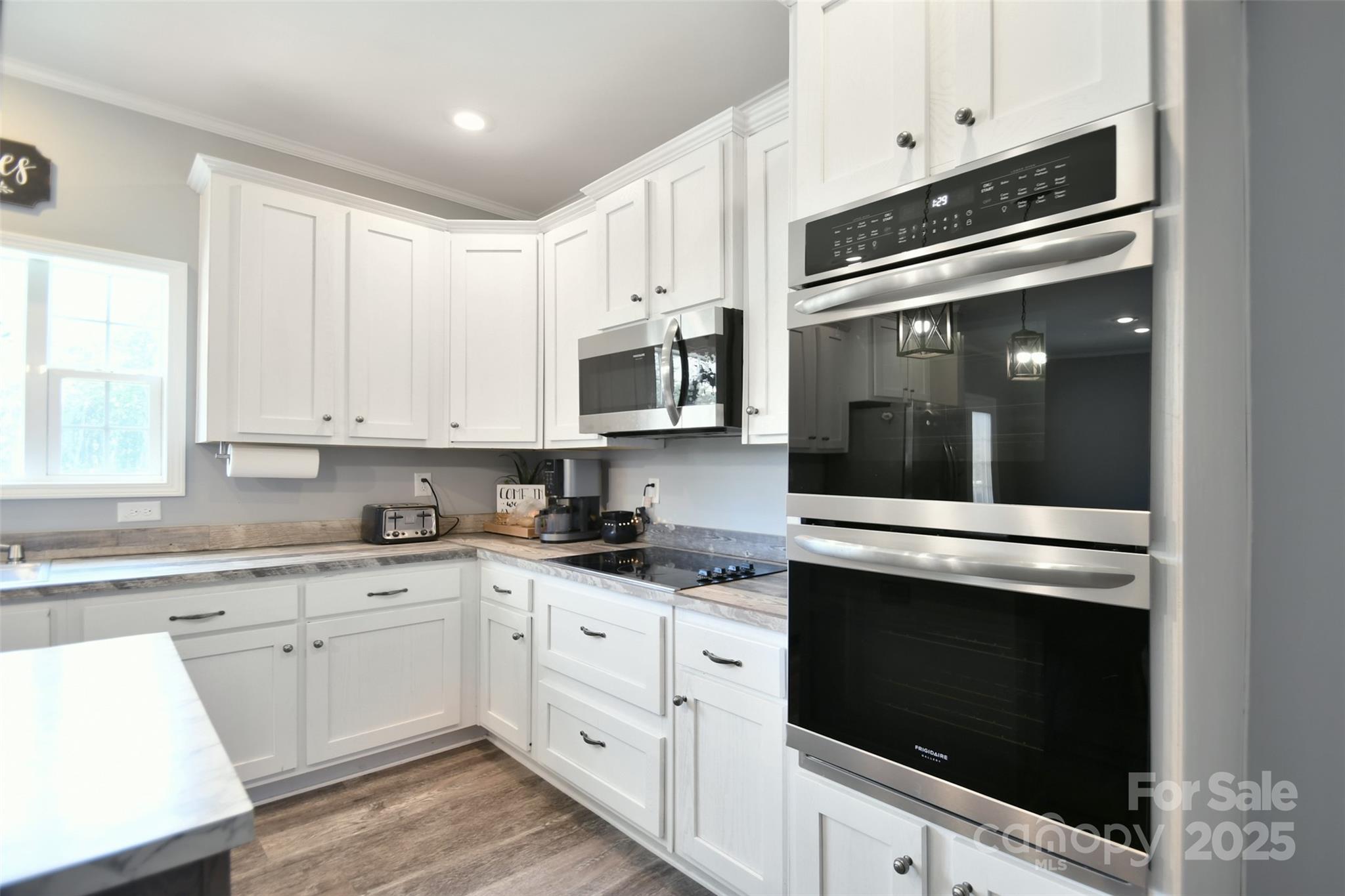 265 St Matthew Church Road Salisbury, NC 28146 - Photo 15 of 42 a kitchen with granite countertop white cabinets and stainless steel appliances