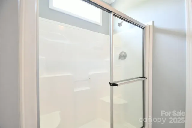 a bathroom with a glass shower door