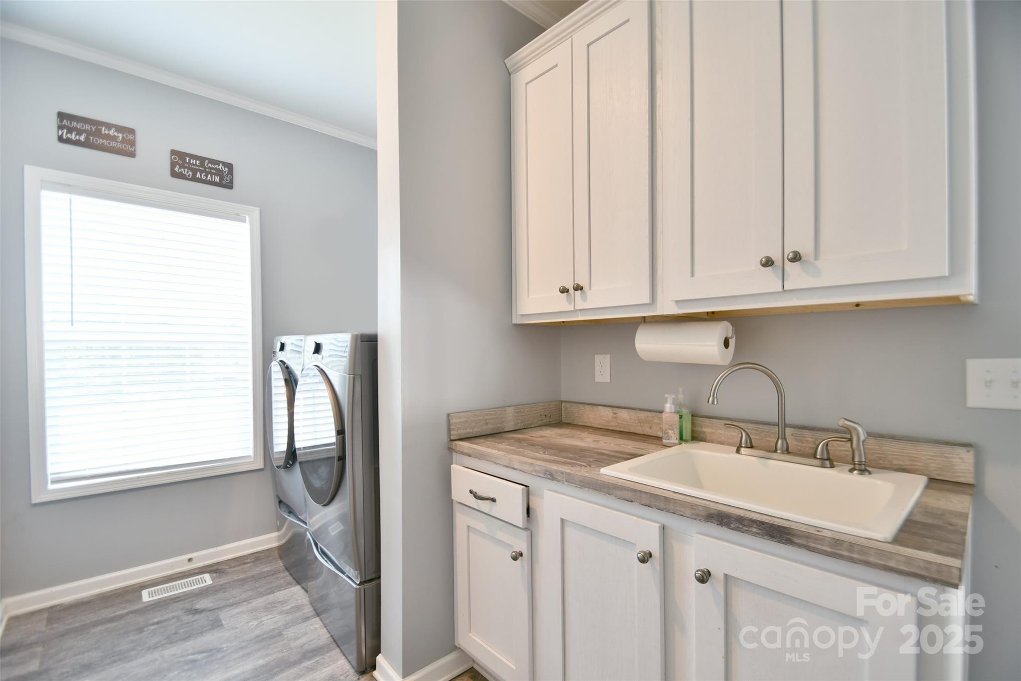 265 St Matthew Church Road Salisbury, NC 28146 - Photo 22 of 42 a kitchen with stainless steel appliances granite countertop a sink and a white wooden cabinets