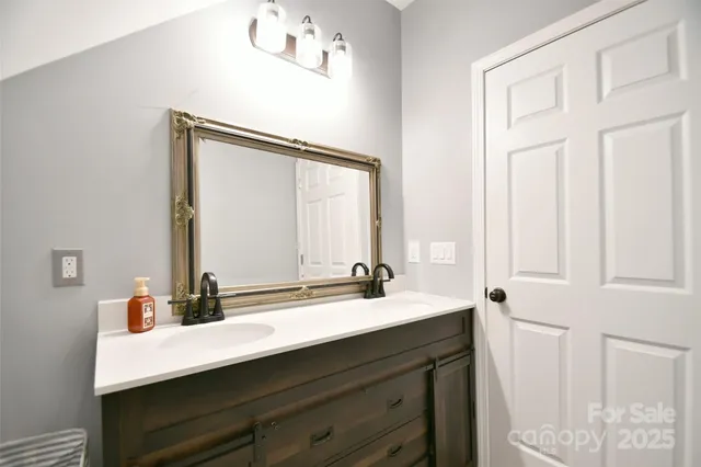 a bathroom with a double vanity sink and a mirror