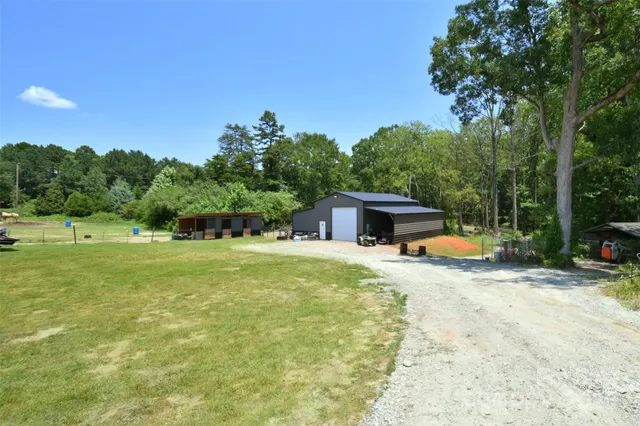 a view of a house with pool and a yard