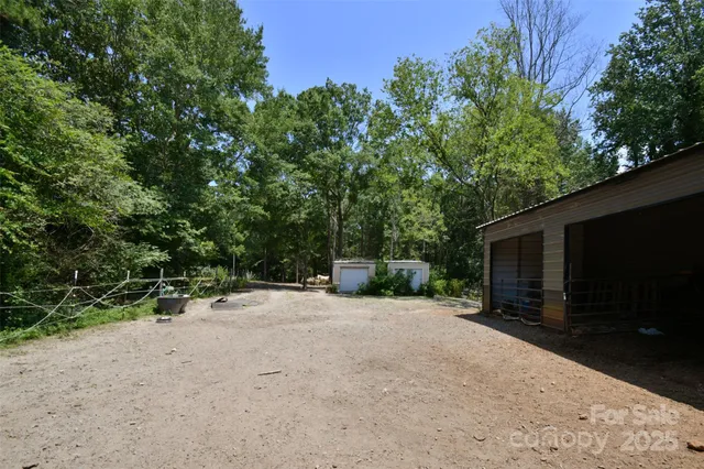 a view of a backyard with furniture and a tree