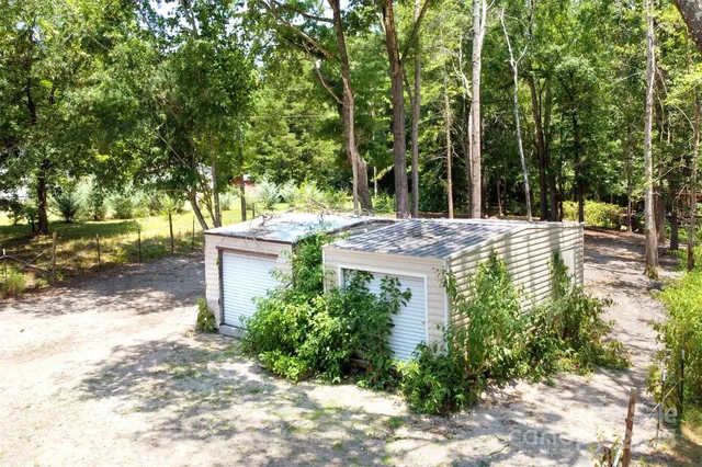 a view of a house with a yard and sitting area