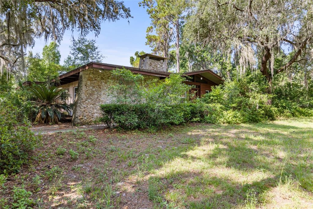 2107 Southwest Williston Road Gainesville, FL 32608 - Photo 1 of 1 a backyard of a house with a yard and outdoor seating