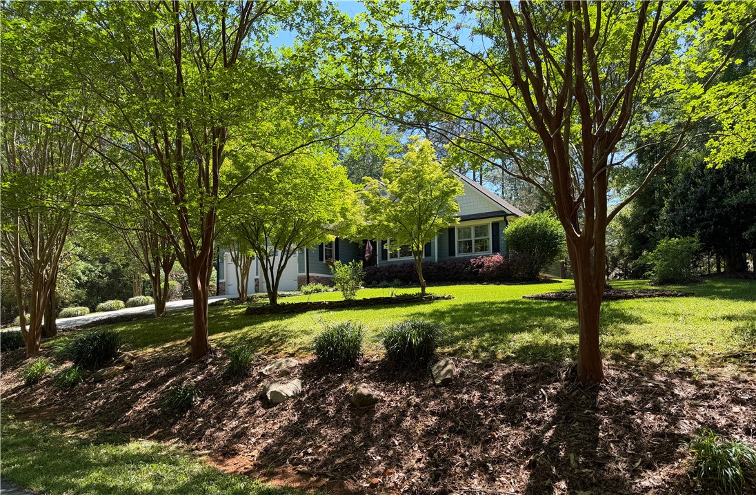 232 Hunters Trail Walhalla, SC 29691 - Photo 32 of 38 This charming residence is nestled among mature trees, offering a serene and verdant setting.