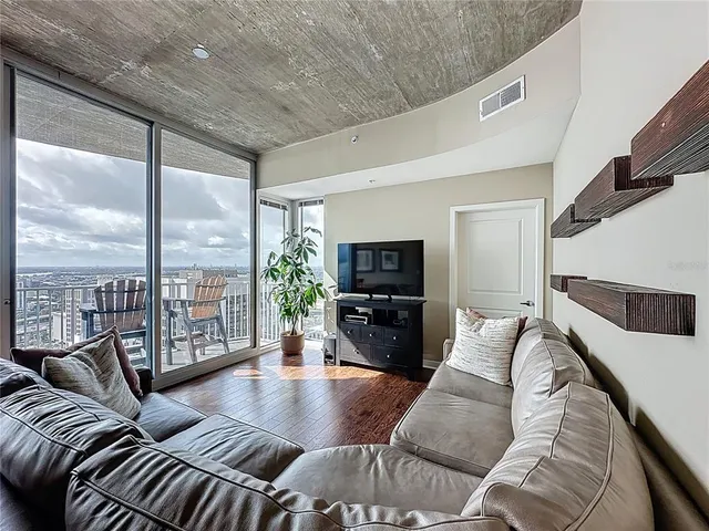 a view of a dining room with furniture wooden floor and a chandelier