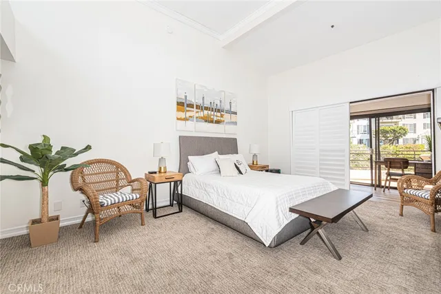 a bedroom with a bed a table and chair