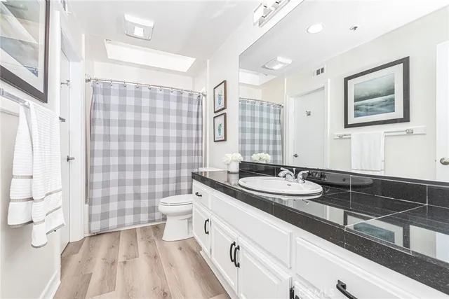 a bathroom with a double vanity sink toilet and shower