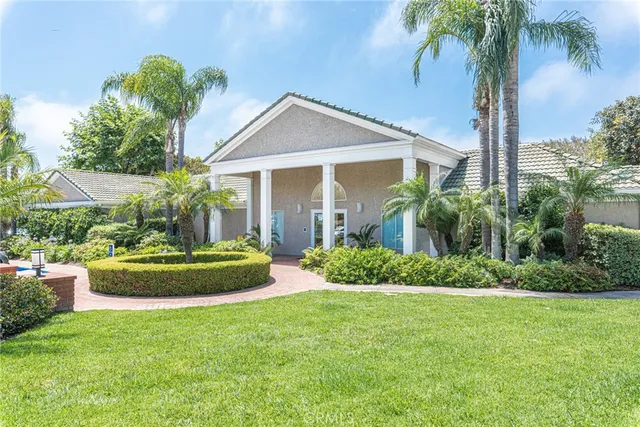 a front view of a house with a garden
