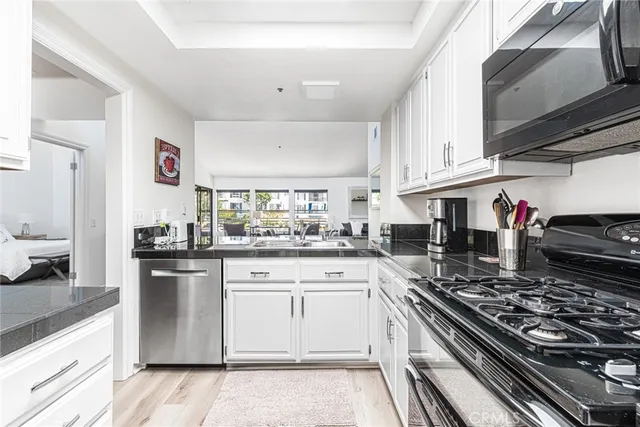 a kitchen with stainless steel appliances granite countertop a stove and a sink