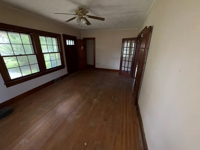 a view of a hallway with wooden floor and entryway