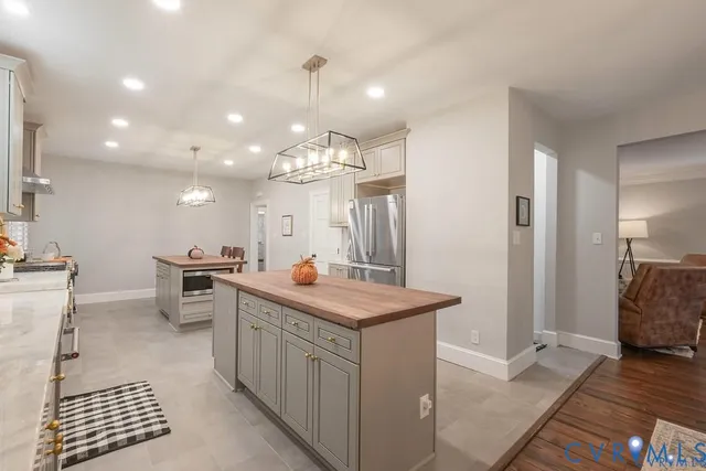 a kitchen with kitchen island a sink stove and refrigerator