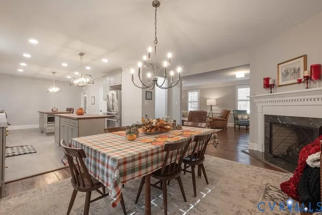 a view of a dining room with furniture and a chandelier