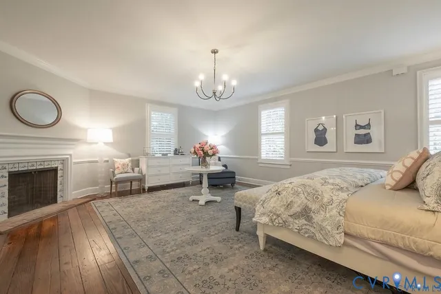 a bedroom with bed and a chandelier
