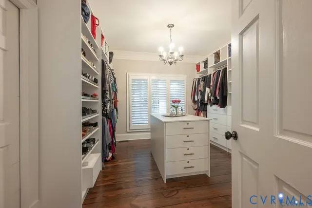 a view of walk in closet with clothes and shoes