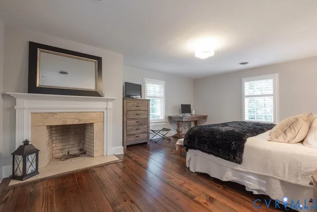 a spacious bedroom with a bed and a fireplace