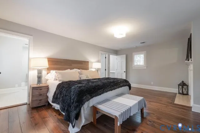 a bedroom with a bed and a night stand