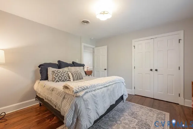 a bedroom with a bed and a dresser