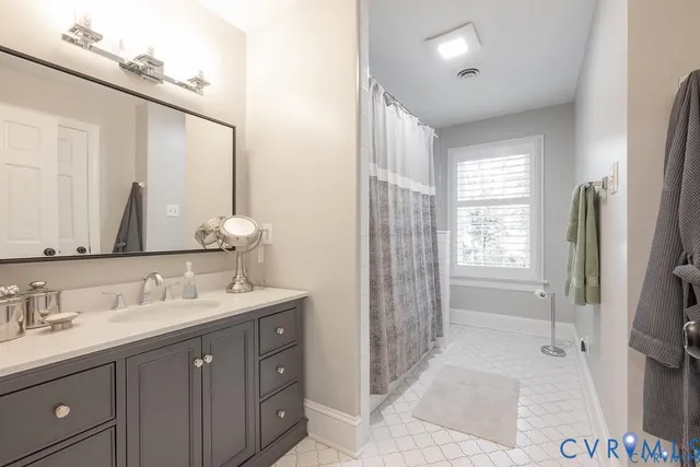 a view of bathroom with a sink a mirror and a shower