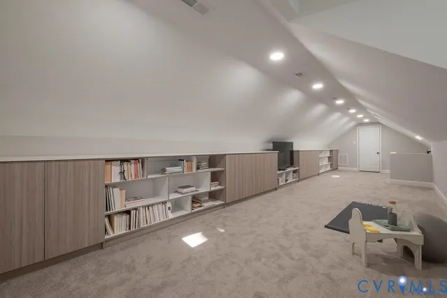 a living room with furniture and a book shelf