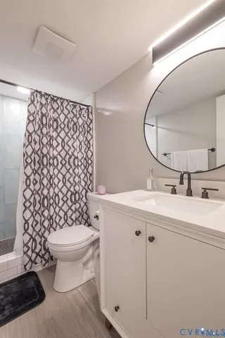 a bathroom with a sink toilet mirror and shower