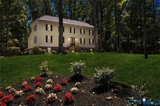 a view of a house with a yard and garden