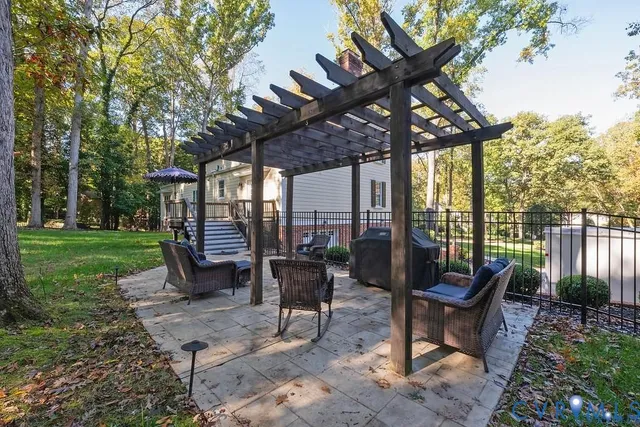 a view of a patio with a table chairs and a backyard