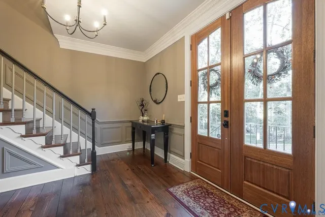 a view of an entryway with wooden floor